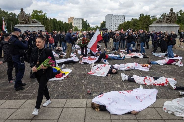 Des manifestants simulent la mort devant le mémorial soviétique à Varsovie